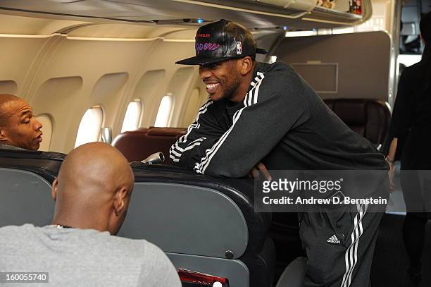 Chris Paul of the Los Angeles Clippers shares a laugh with teammates on the plane to take on the Phoenix Suns on January 24, 2013 in Phoenix,...