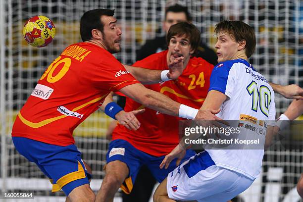 Gedeon Guardiola and Viran Morros of Spain defend against Jure Dolenec of Slovenia during the Men's Handball World Championship 2013 semi final match...