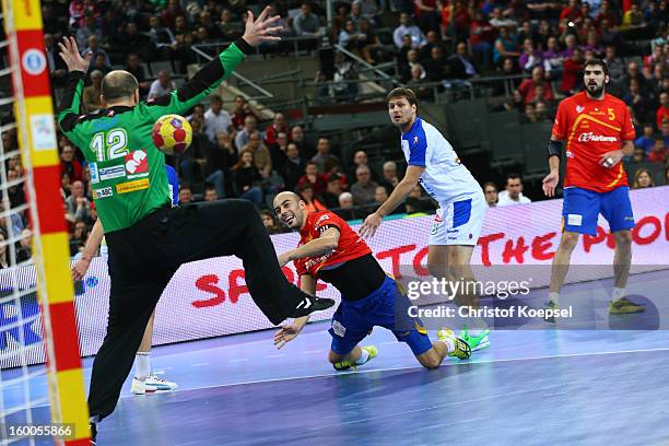 Albert Roca of Spain scores a goal Gorzad Skof of Slovenia during the Men's Handball World Championship 2013 semi final match between Spain and...