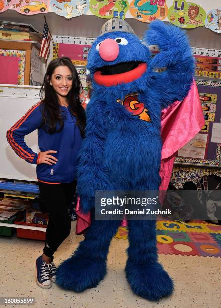 Knicks dancer Dominique and Super Grover teach kids to be a super hero at the WHEDCo classroom on January 24, 2013 in New York City.