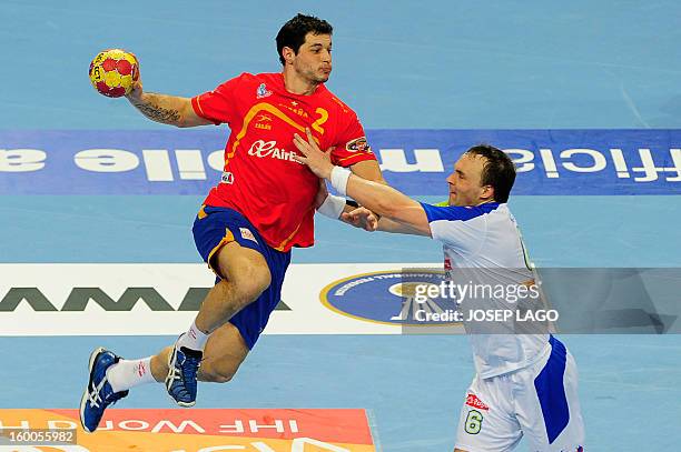 Spain's left back Alberto Entrerrios shoots past Slovenia's pivot Peter Pucelj during the 23rd Men's Handball World Championships semifinal match...