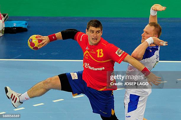 Spain's pivot Julen Aguinagalde shoots past Slovenia's pivot Miha Zvizej during the 23rd Men's Handball World Championships semifinal match Spain vs...