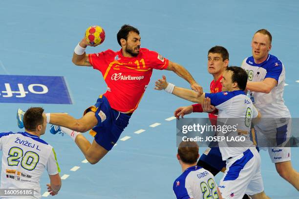 Spain's centre back Daniel Sarmiento shoots past Slovenian players during the 23rd Men's Handball World Championships semifinal match Spain vs...
