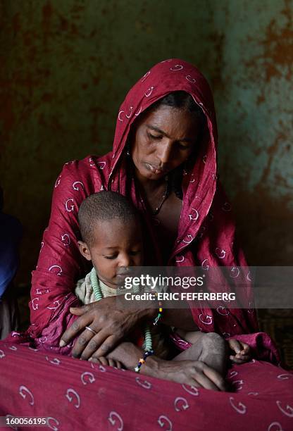 Zahra Ag Noh holds on January 25, 2013 her son Aboubakrim in her hom in the village of Seribala, 20 kms from Niono, about 350 kms northeast of the...