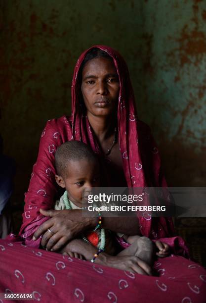 Zahra Ag Noh holds on January 25, 2013 her son Aboubakrim in her hom in the village of Seribala, 20 kms from Niono, about 350 kms northeast of the...