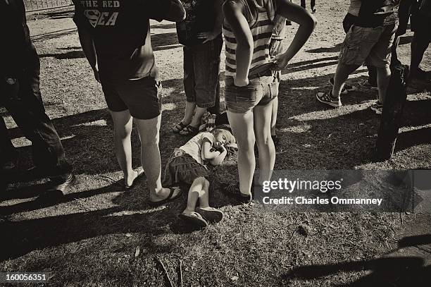 Young girl sleeps as US President Barack Obama delivers remarks during a campaign event at Herman Park in Boone, Iowa, on August 13, 2012.