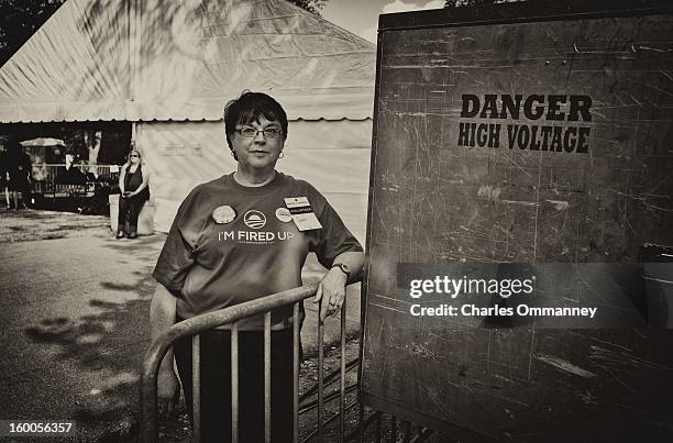 Supporter looks on as US President Barack Obama delivers remarks during a campaign event at Herman Park in Boone, Iowa, on August 13, 2012.