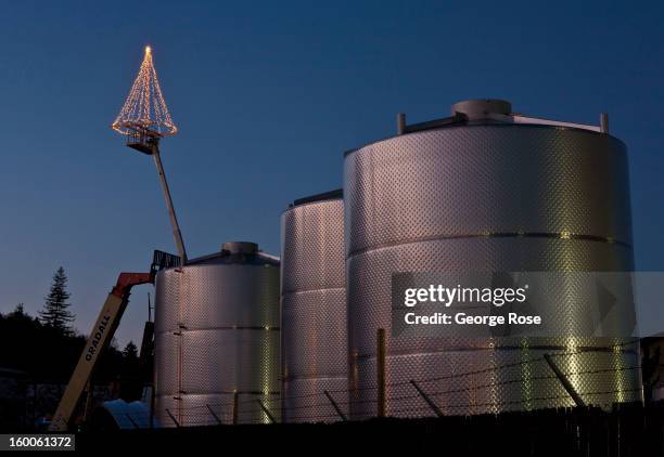 Christmas tree is decked out with holiday lights and decorations and hung from a crane on December 17 in Healdsburg, California. Though much of the...