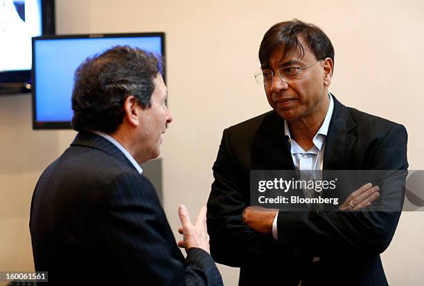 Lakshmi Mittal, chief executive officer of ArcelorMittal, right, speaks to a fellow delegate on day three of the World Economic Forum in Davos,...