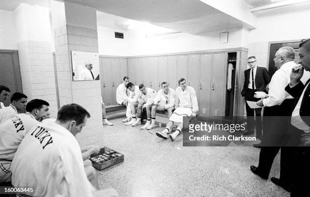 Kentucky coach Adolph Rupp talking to players in locker room before game vs Mississippi at Memorial Coliseum. View of his reflection in the mirror....
