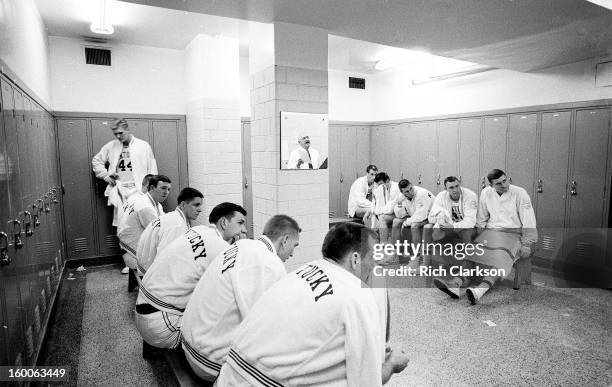 View of Kentucky players listening to coach Adolph Rupp in locker room before game vs Mississippi at Memorial Coliseum. View of Rupp's reflection in...