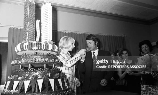 Salvatore Adamo coupant le gâteau sous les yeux de son épouse dans une soirée sponsorisée par 'Martini', en 1969.