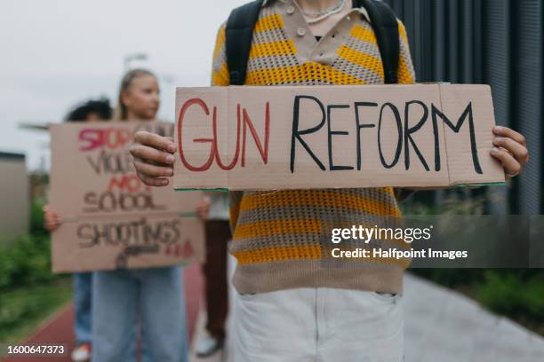 young zoomers students marching through the city demonstrate against gun violence. - gun control stock pictures, royalty-free photos & images