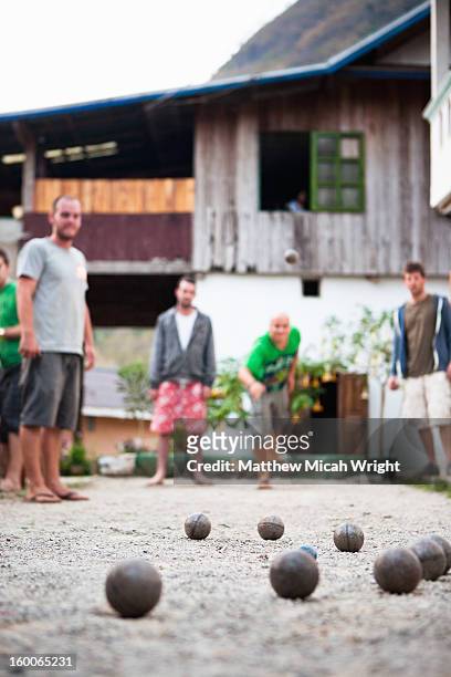 travelers playing a local game of petanque - petanque stock pictures, royalty-free photos & images