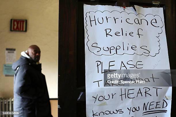 Residents pick-up items at a church which has been turned into a relief supply center following Hurricane Sandy in the Rockaways on January 25, 2013...