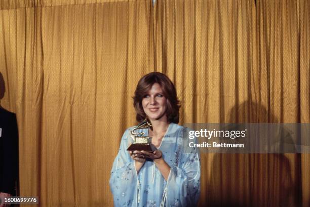 American singer Debby Boone holding the best new artist trophy during the 20th Anniversary Grammy Awards at the Shrine Auditorium, Los Angeles,...