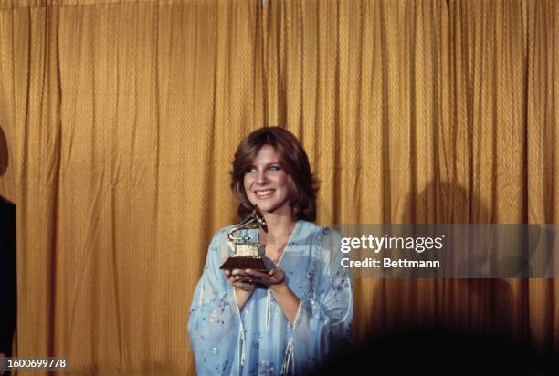 American singer Debby Boone holding the best new artist trophy during the 20th Anniversary Grammy Awards at the Shrine Auditorium, Los Angeles,...