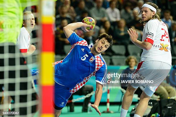 Croatia's centre back Domagoj Duvnjak shoots past Denmark's left back Mikkel Hansen during the 23rd Men's Handball World Championships semifinal...