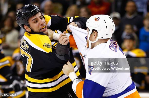 Milan Lucic of the Boston Bruins and Matt Carkner of the New York Islanders fight in the first period during the game on January 25, 2013 at TD...