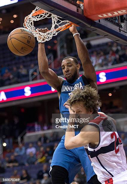 Minnesota Timberwolves power forward Derrick Williams slam dunks over Washington Wizards small forward Jan Vesely during the first half of their game...