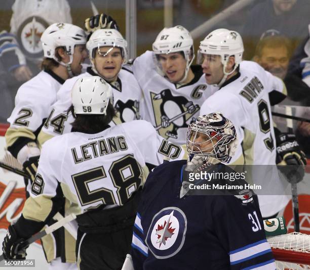 Ondrej Pavelec of the Winnipeg Jets reacts after a goal by Sidney Crosby of the Pittsburgh Penguins during first-period action on January 25, 2013 at...