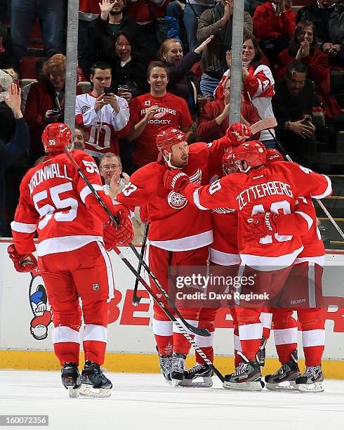 Niklas Kronwall of the Detroit Red Wings skates over to celebrate with his teamates Johan Franzen, Pavel Datsyuk, Henrik Zetterberg and Damien...