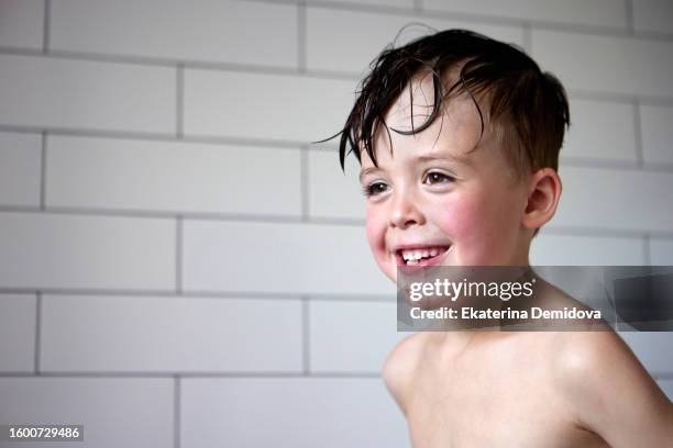 closeup portrait of a wet little boy in bathroom - boys taking a shower stock pictures, royalty-free photos & images