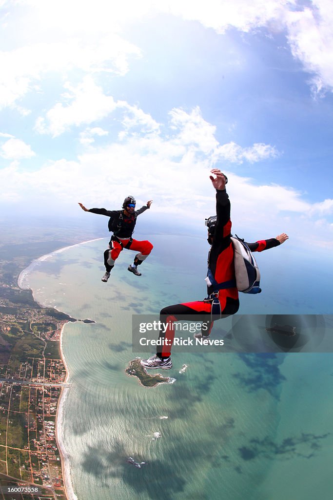 Skydivers Skydivers In Freefall Over The Beach High-Res Stock Photo - Getty Images