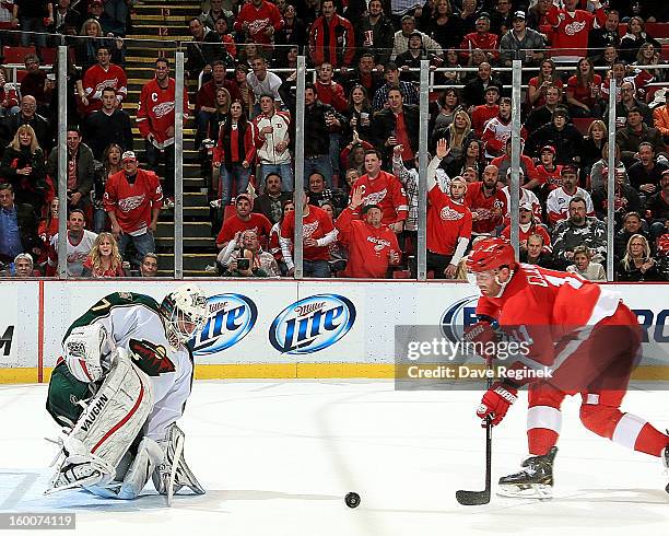 Daniel Cleary of the Detroit Red Wings shoots the puck on Josh Harding of the Minnesota Wild during a NHL game at Joe Louis Arena on January 25, 2013...