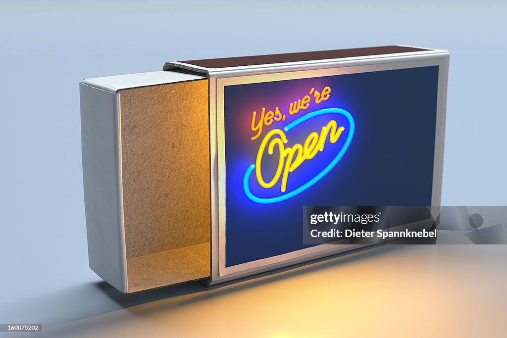 Illuminated neon sign outside of an open matchbox