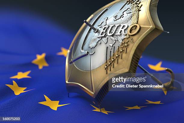 euro coin designed umbrella on a flag of europe - 欧州金融安定ファシリティ ストックフォトと画像