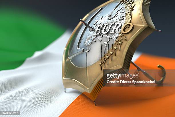 euro coin designed umbrella on a flag of ireland - 欧州金融安定ファシリティ ストックフォトと画像