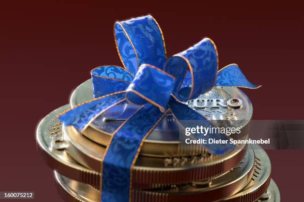 stack of one euro coins with blue gift ribbon - pennies from heaven stock illustrations