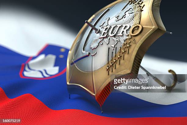 euro coin designed umbrella on a flag of slovenia - 欧州金融安定ファシリティ ストックフォトと画�像
