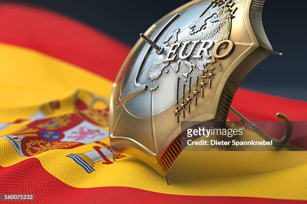 euro coin designed umbrella on a flag of spain - 欧州金融安定ファシリティ ストックフォトと画像