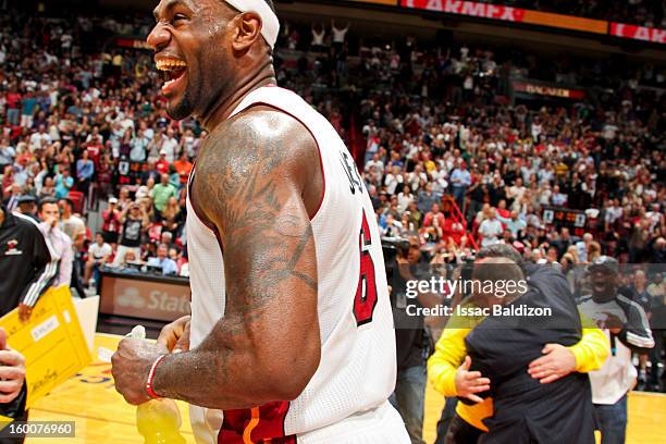 LeBron James of the Miami Heat celebrates after fan Michael Drysch made a half-court shot to win $75,000 for himself and $75,000 for the LeBron James...