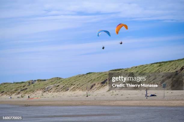 People enjoy paragliding in the 6 Km long beach on August 13, 2023 in Rockanje, Netherlands.