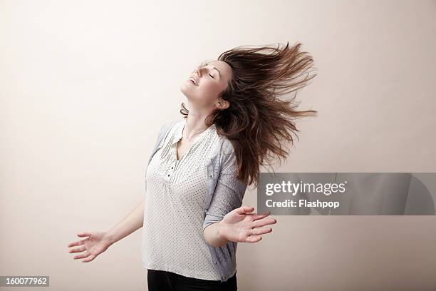 portrait of carefree woman - hair flying stock-fotos und bilder