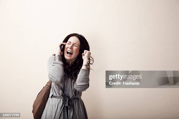 woman using phone - furious stock pictures, royalty-free photos & images