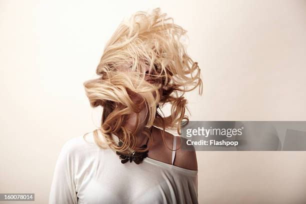 portrait of woman feeling carefree - tousled hair stock-fotos und bilder