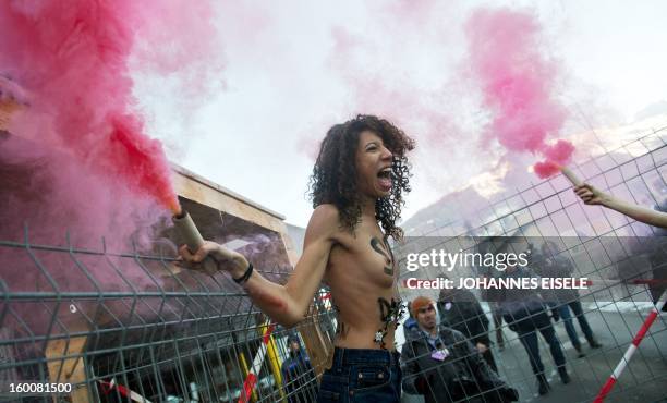 Activists from the Ukrainian feminist group FEMEN shout slogans during a topless protest on January 26 against the World Economic Forum 2013 annual...