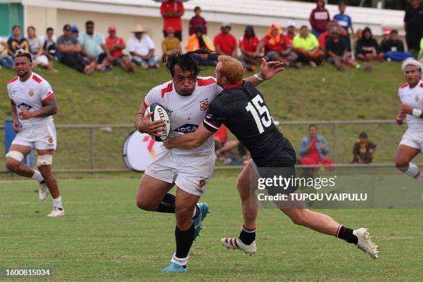 Tonga's Sosefo Sakalia is tackled by Canada's Peter Nelson during their international friendly rugby match in Nuku'alofa on August 15, 2023.