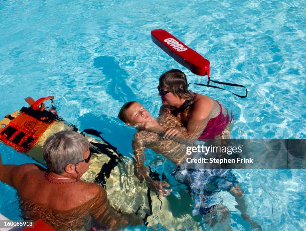 possible spinal injury and drowning - lifeguard stock pictures, royalty-free photos & images