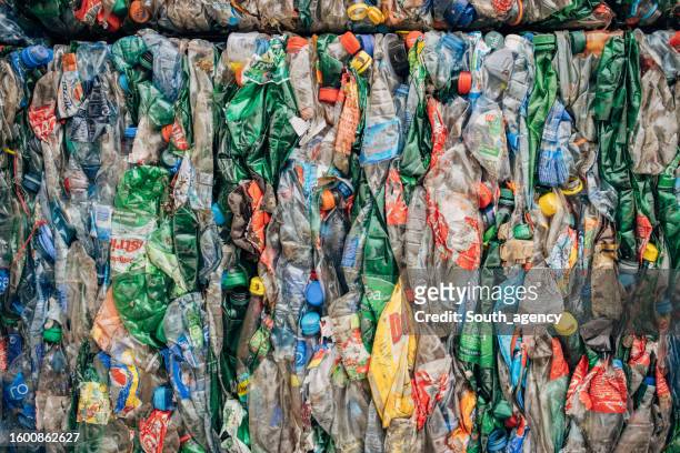 recycling centre with plastic garbage piles ready to recycle - biodegradable plastic stock pictures, royalty-free photos & images