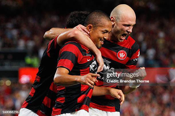 Shinji Ono of the Wanderers celebrates with team mates Dino Kresinger and Mark Bridge after scoring a penalty during the round 18 A-League match...