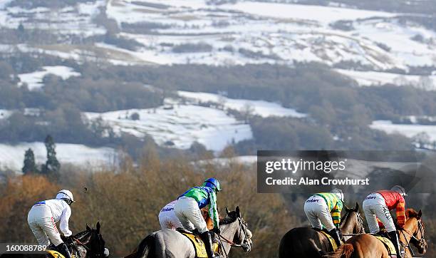 Runners in The JCB Triumph Hurdle Trial take the top bend towards the snow covered Cleeve Hill at Cheltenham racecourse on January 26, 2013 in...