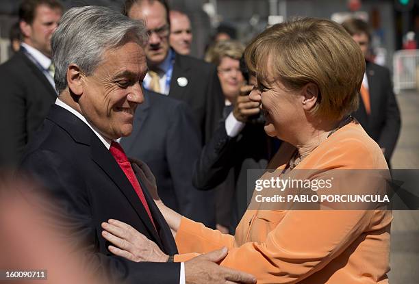 Chilean President Sebastian Pinera and German Chancellor Angela Merkel chat at La Moneda presidential palace in Santiago as part of her official...