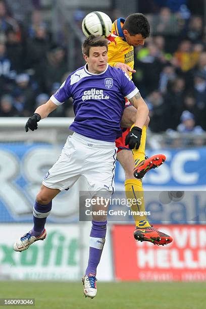 Nils Fischer of Osnabrueck challenges Koen van der Biezen of Karlsruhe during the Third league match between VfL Osnabrueck and Karlsruher SC at...