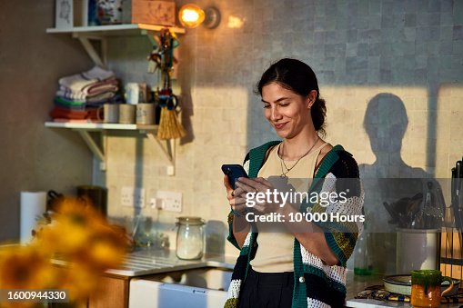 Smiling mid adult woman using social media on smart phone Smiling mid adult woman using social media on smart phone