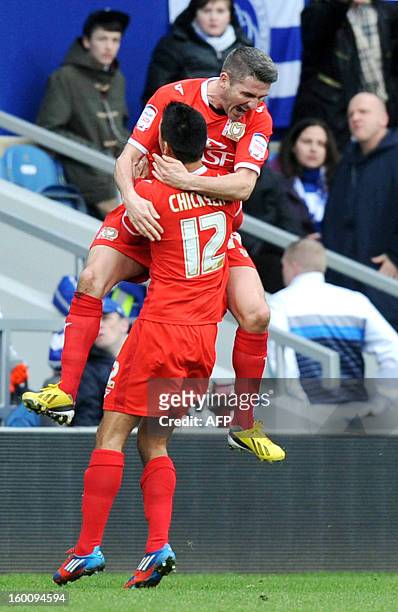 Dons Ryan Lowe celebrates scoring with Adam Chicksen against Queens Park Rangers during the FA Cup fourth round football match between QPR and MK...